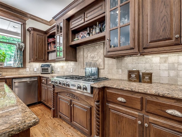3125 Cumberland Dr, Edmond, OK 73034 - kitchen with appliances with stainless steel finishes, open shelves, backsplash, ornamental molding, and light stone countertops