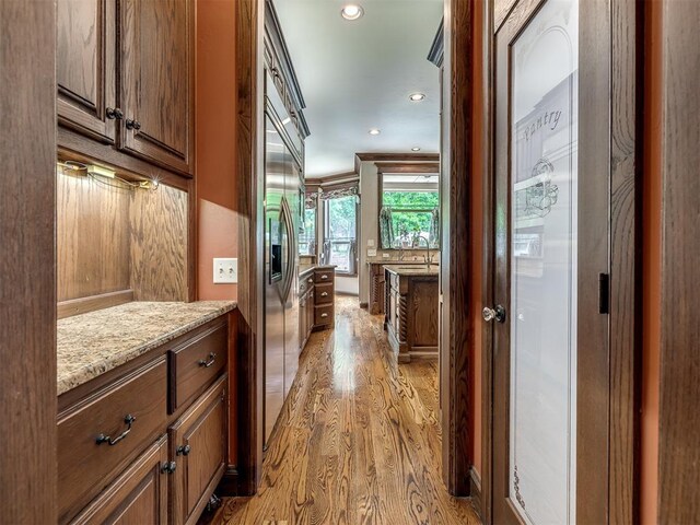 3125 Cumberland Dr, Edmond, OK 73034 - hall with light wood-type flooring, recessed lighting, and a sink