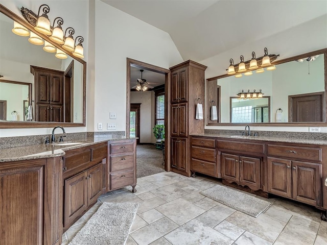 3125 Cumberland Dr, Edmond, OK 73034 - full bath with healthy amount of natural light, lofted ceiling, a ceiling fan, and two vanities