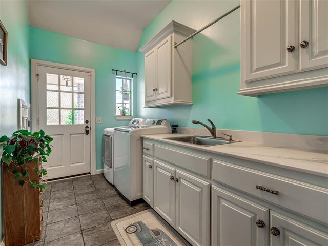 3125 Cumberland Dr, Edmond, OK 73034 - clothes washing area with separate washer and dryer, cabinet space, and baseboards