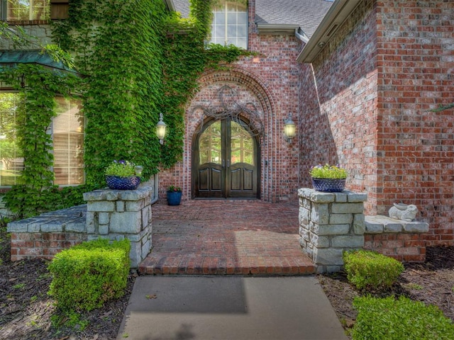 3125 Cumberland Dr, Edmond, OK 73034 - entrance to property featuring french doors, brick siding, and roof with shingles