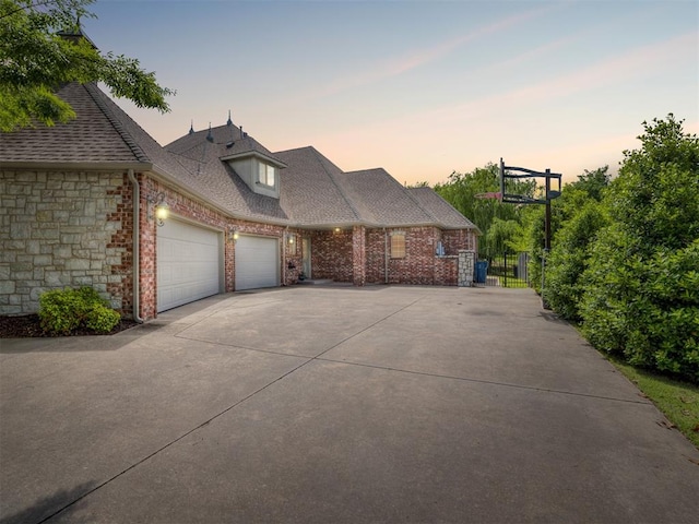 3125 Cumberland Dr, Edmond, OK 73034 - view of front facade with an attached garage, concrete driveway, a shingled roof, and brick siding