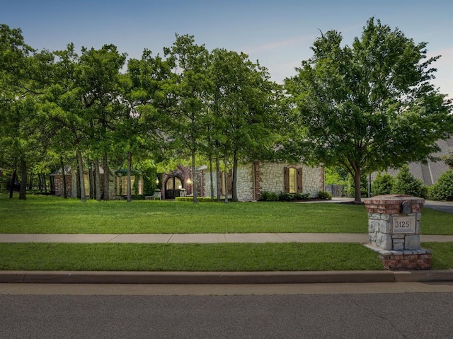 3125 Cumberland Dr, Edmond, OK 73034 - view of property hidden behind natural elements with stone siding and a front yard