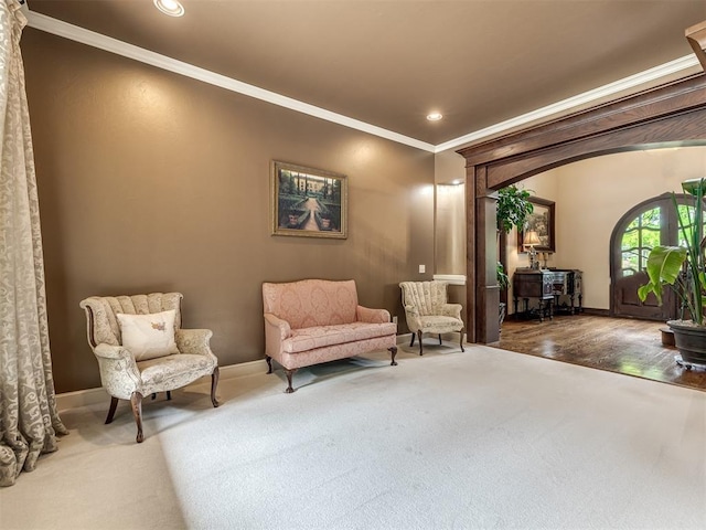 3125 Cumberland Dr, Edmond, OK 73034 - sitting room with crown molding, baseboards, carpet floors, recessed lighting, and arched walkways