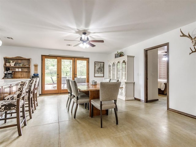 dining space with french doors, a ceiling fan, concrete flooring, and visible vents