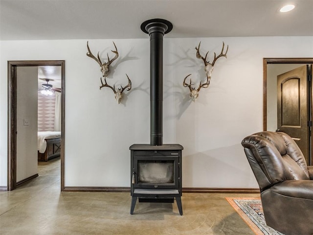details with recessed lighting, baseboards, and a wood stove