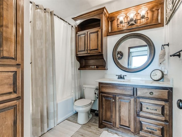 full bathroom with toilet, wood finished floors, shower / bath combo, and vanity