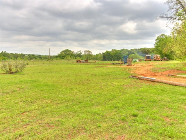 view of yard with playground community and a rural view