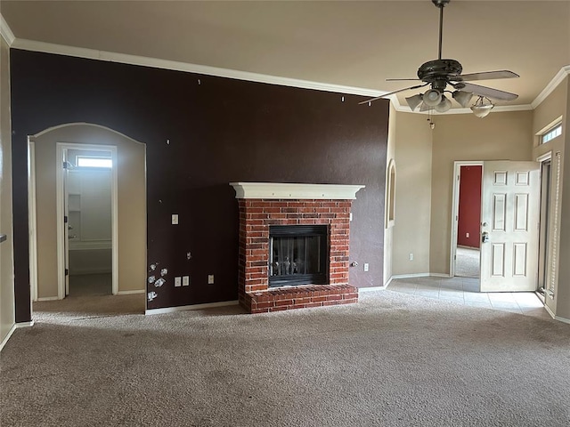 unfurnished living room with baseboards, a ceiling fan, light carpet, and ornamental molding