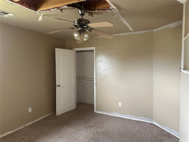 unfurnished bedroom featuring visible vents, carpet floors, a closet, and ceiling fan