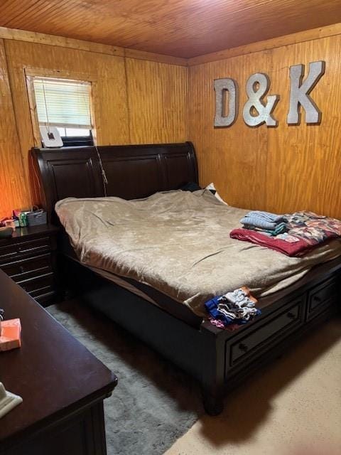 bedroom featuring wooden ceiling, carpet flooring, and wood walls