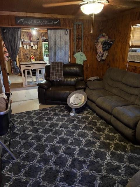living room with wood walls, a ceiling fan, and cooling unit