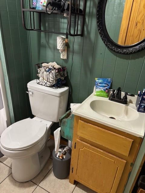bathroom with tile patterned flooring, toilet, and vanity