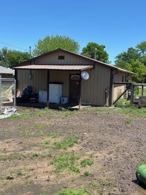 view of outbuilding with fence