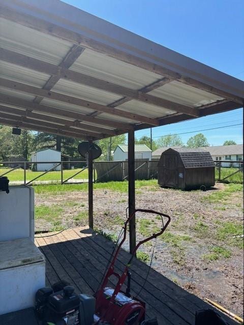 exterior space with fence and a shed