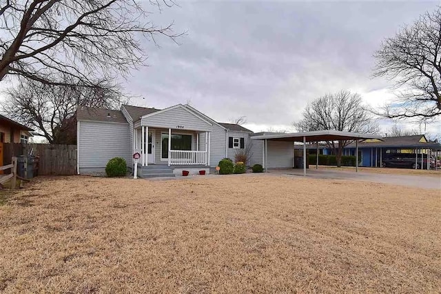 1904 NW Euclid Ave, Lawton, OK 73507 - view of front of house featuring a porch, driveway, a front yard, a carport, and fence