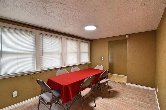 1904 NW Euclid Ave, Lawton, OK 73507 - dining area with plenty of natural light, a textured ceiling, light wood finished floors, and baseboards