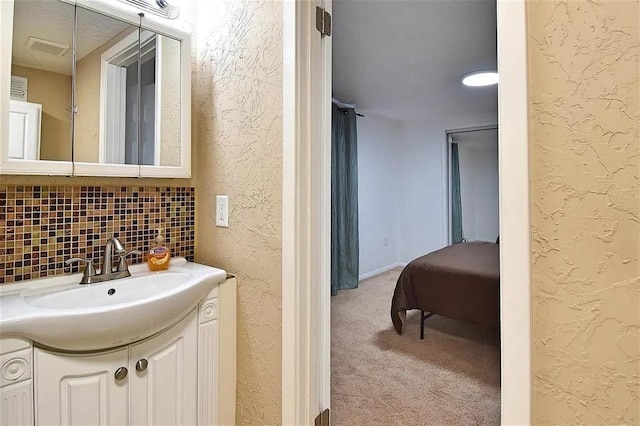 1904 NW Euclid Ave, Lawton, OK 73507 - bathroom with vanity, decorative backsplash, and a textured wall