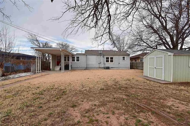 1904 NW Euclid Ave, Lawton, OK 73507 - rear view of house with fence, an outbuilding, and a storage unit