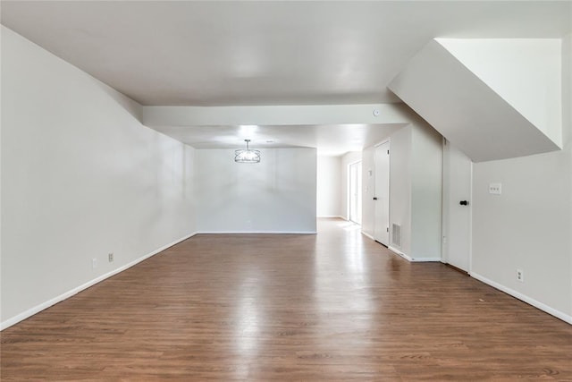 bonus room featuring dark wood-style flooring, baseboards, and visible vents