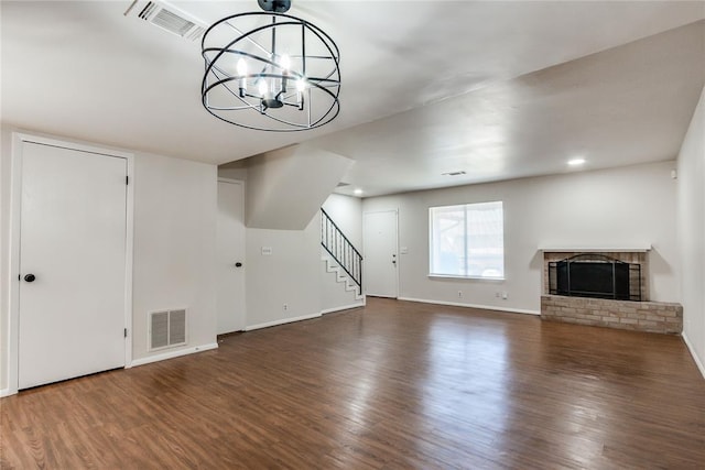 unfurnished living room with visible vents and wood finished floors