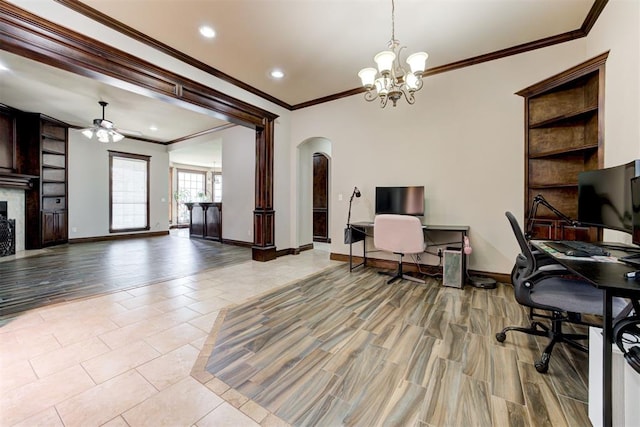 office area featuring crown molding, arched walkways, ceiling fan with notable chandelier, and built in shelves