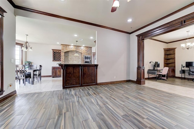 living area featuring wood finished floors, baseboards, ceiling fan with notable chandelier, ornamental molding, and recessed lighting