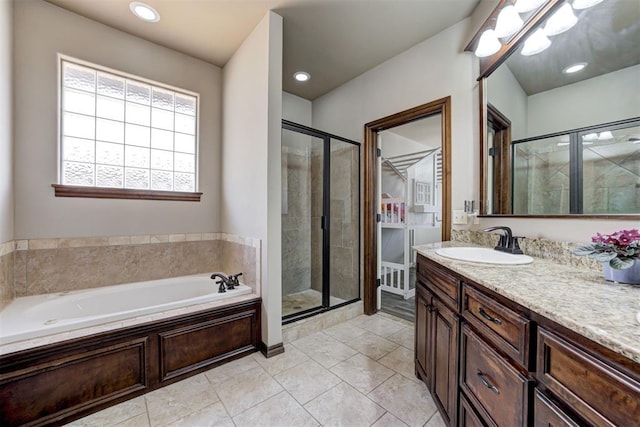 bathroom featuring vanity, recessed lighting, a bath, and a stall shower