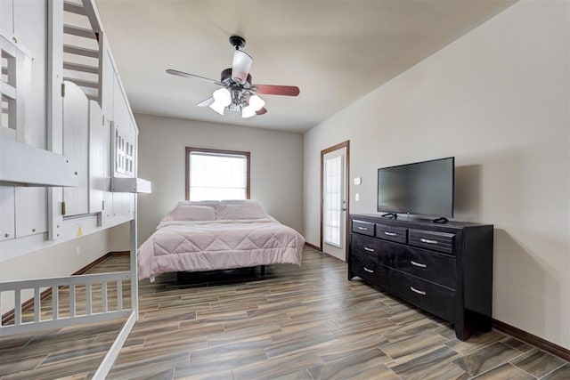 bedroom with baseboards, ceiling fan, and light wood-style flooring