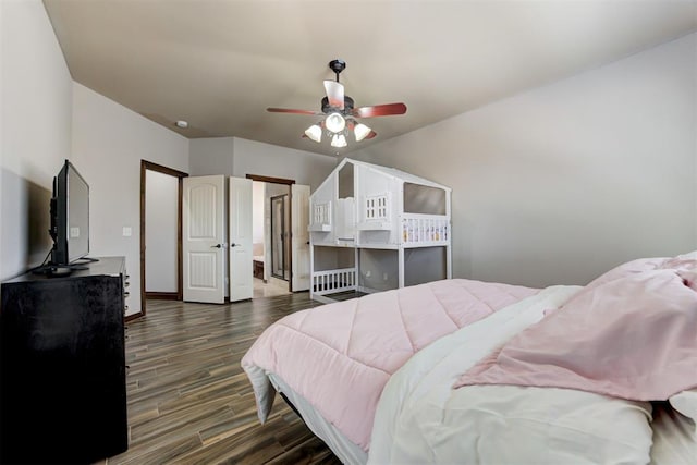 bedroom with baseboards, ceiling fan, and dark wood-type flooring