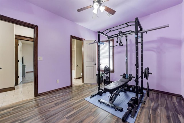 workout room featuring baseboards, a ceiling fan, wood finished floors, and visible vents