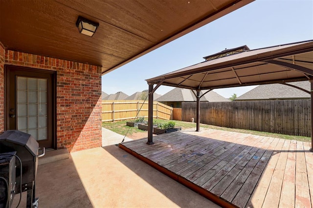 view of patio featuring a gazebo, a fenced backyard, grilling area, and a deck