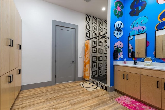 full bathroom featuring recessed lighting, wood finished floors, and vanity