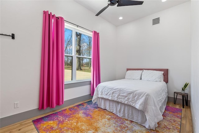 bedroom featuring recessed lighting, a ceiling fan, visible vents, and wood finished floors