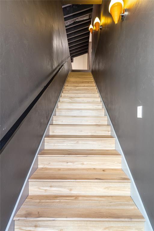 stairway featuring wood finished floors