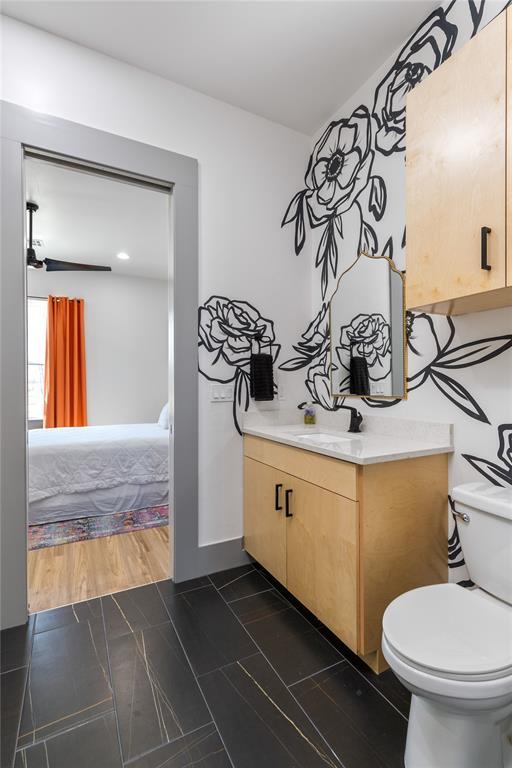 half bathroom with vanity and toilet