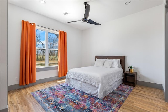 bedroom with a ceiling fan, visible vents, recessed lighting, and light wood finished floors