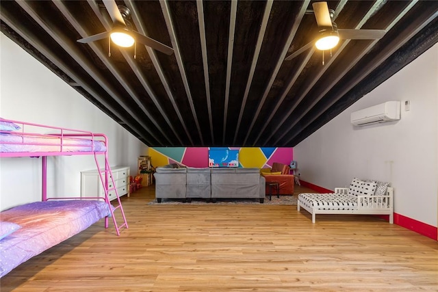 bedroom with baseboards, a wall mounted AC, wood finished floors, and vaulted ceiling