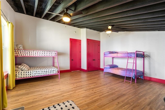 bedroom featuring baseboards, ceiling fan, and wood finished floors