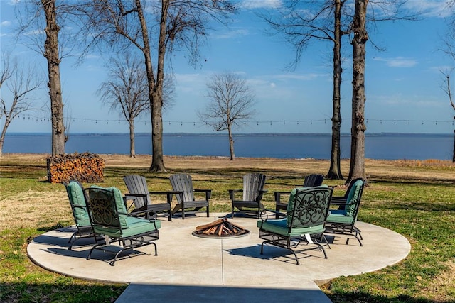 view of patio / terrace featuring a water view and a fire pit