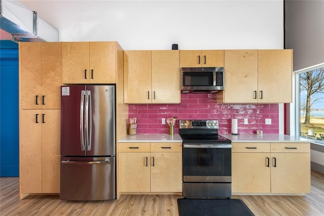 kitchen featuring light countertops, appliances with stainless steel finishes, and light wood-type flooring