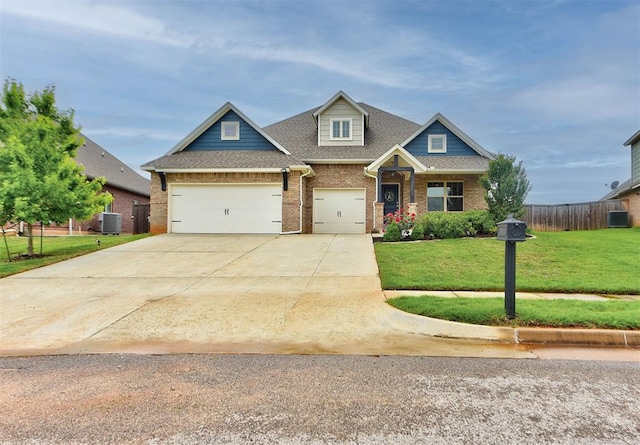 craftsman-style home with a front lawn, brick siding, a garage, central AC unit, and driveway