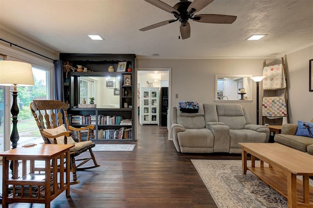 living room featuring crown molding, ceiling fan, and dark wood-type flooring