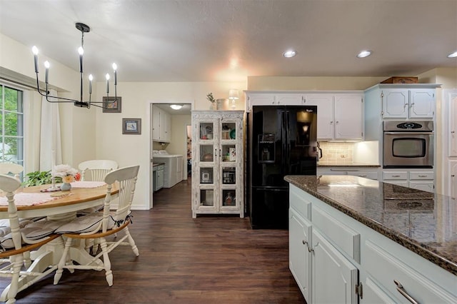 kitchen with oven, an inviting chandelier, black refrigerator with ice dispenser, backsplash, and dark wood-style floors