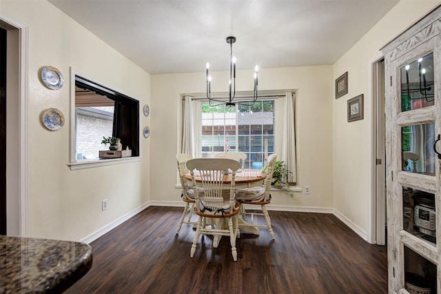dining room featuring baseboards, dark wood-style floors, and a notable chandelier
