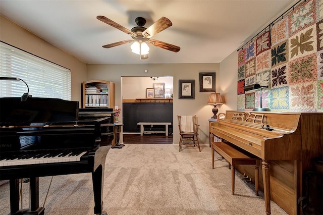 living area with carpet flooring and ceiling fan