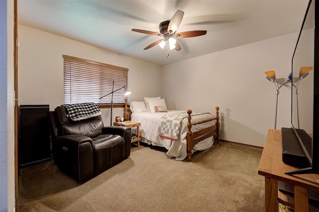 bedroom with a ceiling fan and carpet