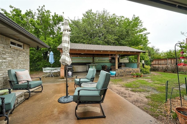 view of patio / terrace featuring a gazebo, fence, and outdoor dining space