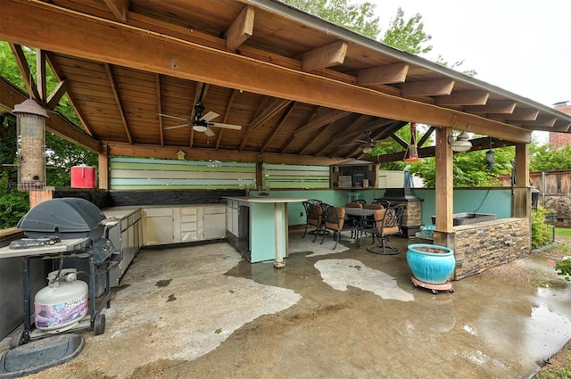 view of patio with a gazebo, ceiling fan, grilling area, and area for grilling