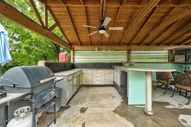 view of patio / terrace with exterior kitchen, ceiling fan, and a grill